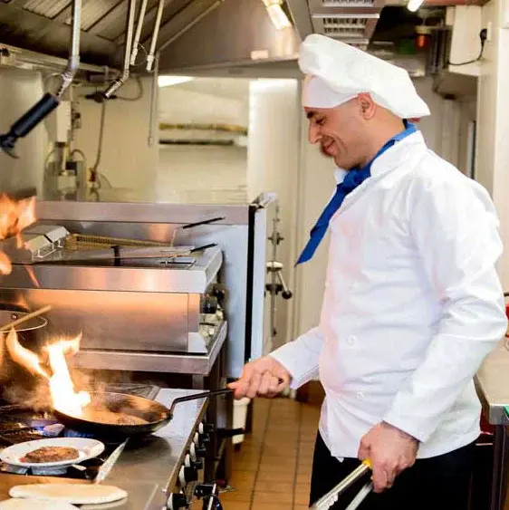 Springwood Landing Chef Created Meals, chef frying a dish.