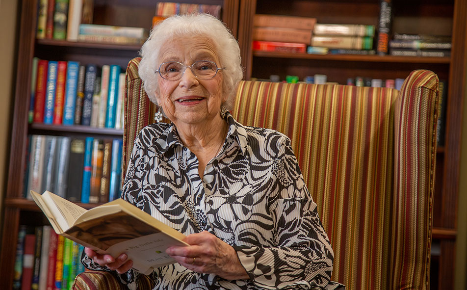The library at Springwood Landing with shelves of books and comfortable seating